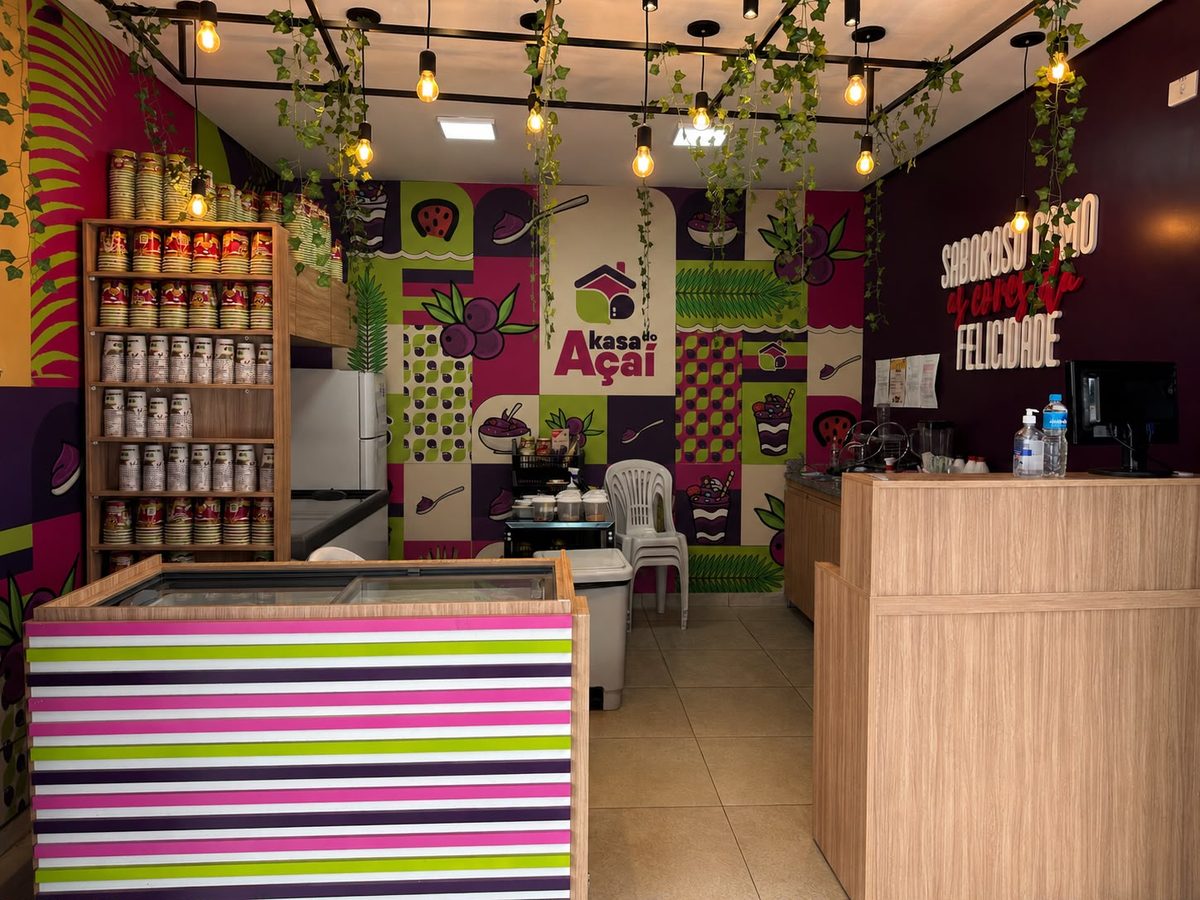 Interior de uma unidade Akasa no modelo To Go, com balcão, freezer e parede temática